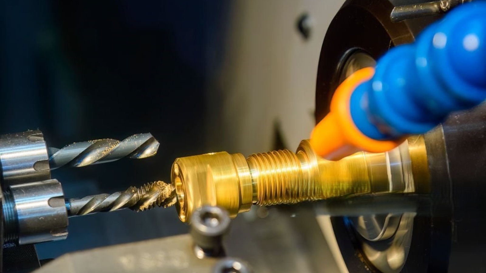 The  multi tasking CNC lathe machine swiss type tapping the brass fitting parts. The hi-technology metal working processing by CNC turning machine .